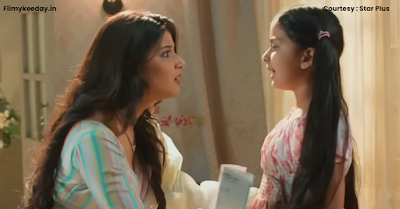 Abhira looking emotional while speaking to a shocked Ruhi, standing in a house setting.