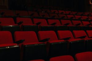 A large empty movie theater auditorium with red seats